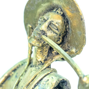 figurine, brass man with pipe, closeup