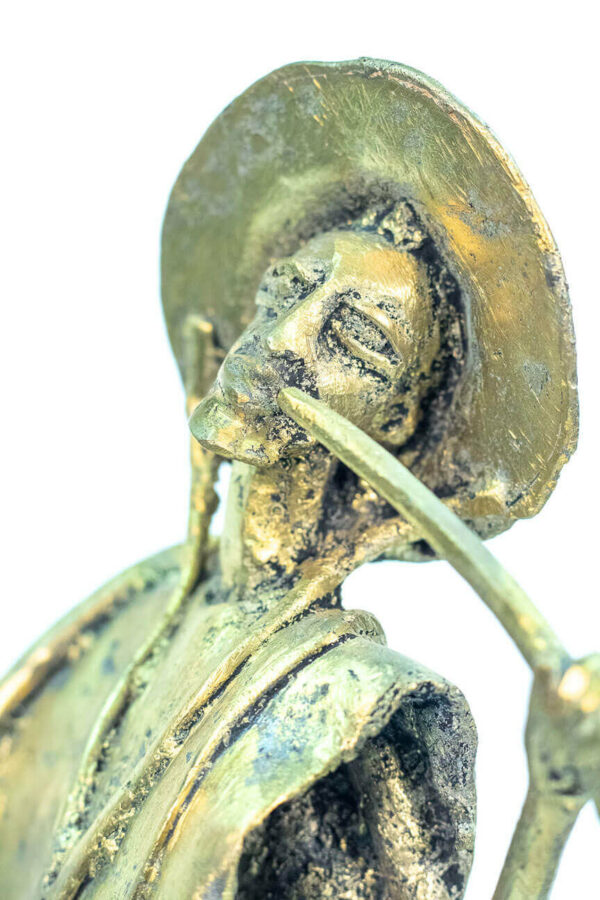 figurine, brass man with pipe, closeup