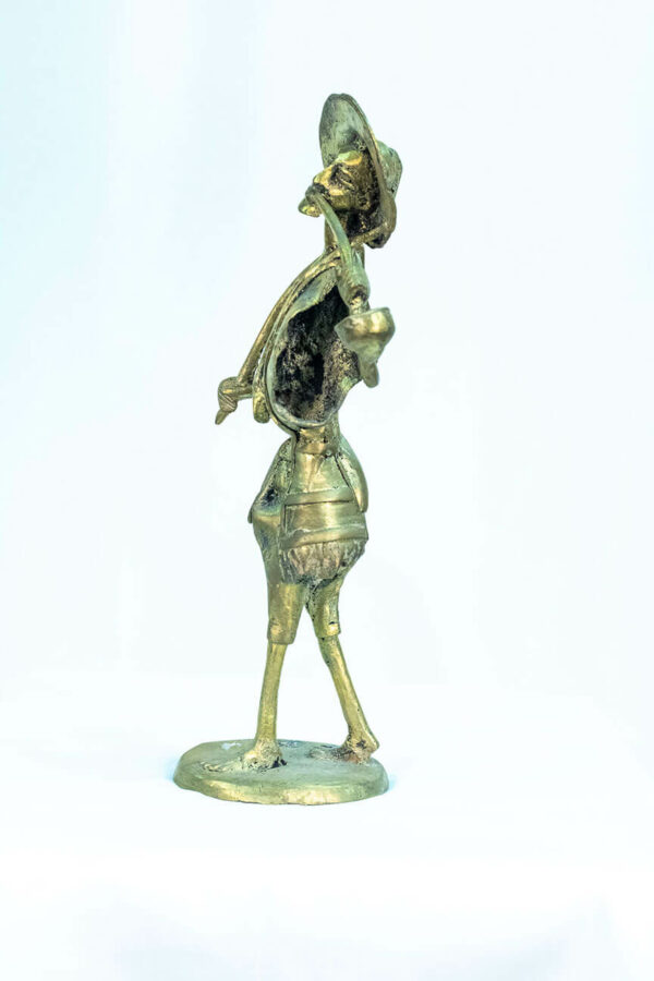 figurine, brass man with pipe, left