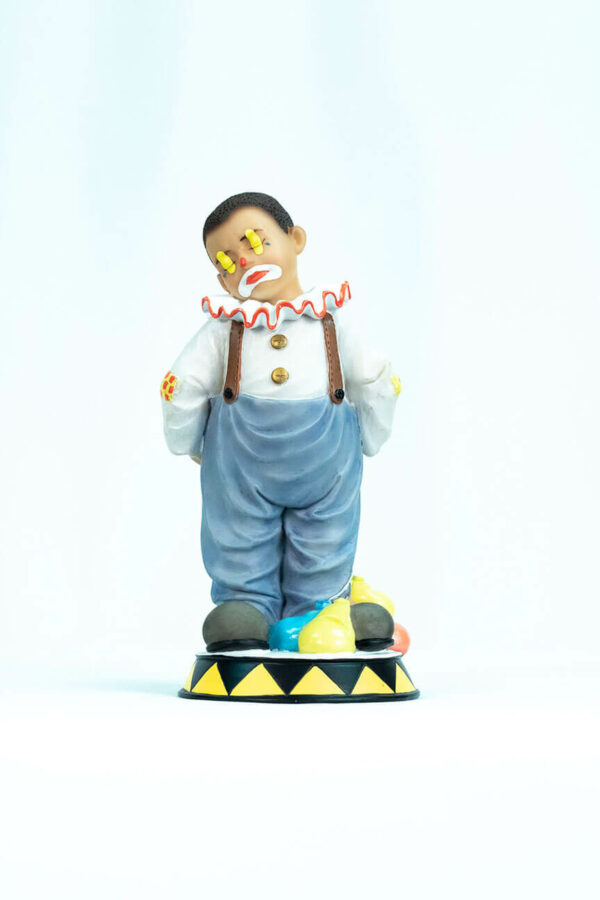 clown figurine, child clown in baggy blue pants, front