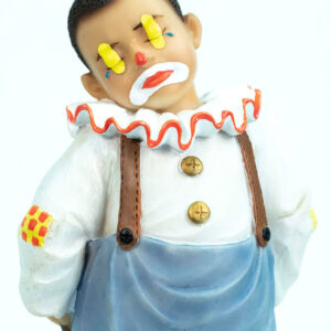 clown figurine, child clown in baggy blue pants, closeup