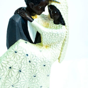 wedding couple figurine, groom holding bride, closeup
