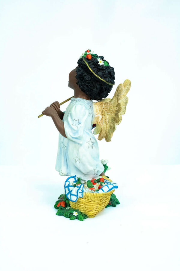 child angel figurine holding colorful flag, left view