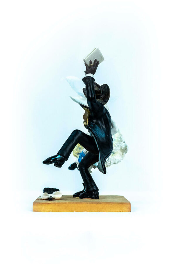 wedding couple figurine, couple jumping broom, left