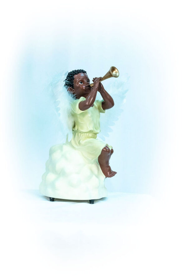 figurine, angel sitting on rock blowing horn, right