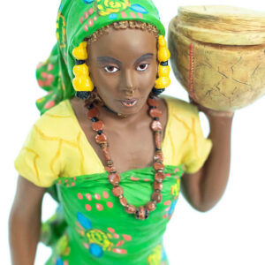 African figurine, Peul woman in green dress holding basket, closeup