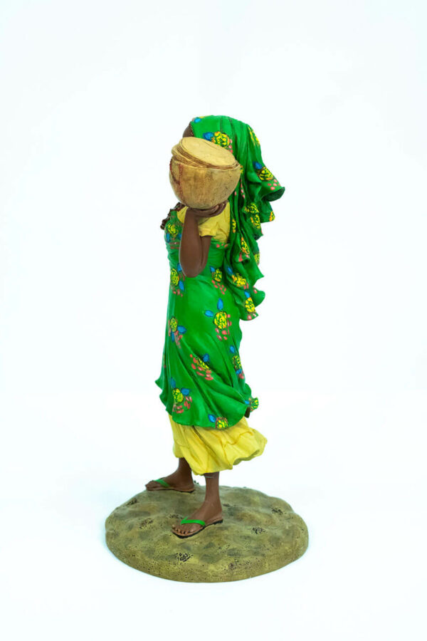 African figurine, Peul woman in green dress holding basket, left