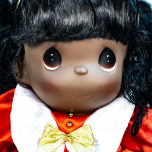 doll, baby doll sitting in red dress, closeup view2