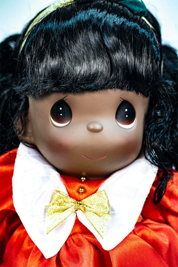 doll, baby doll sitting in red dress, closeup view2