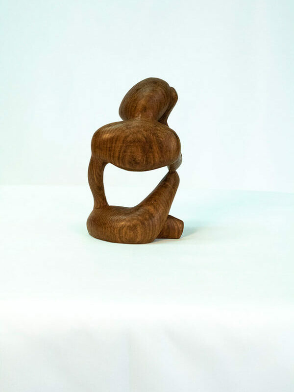 wood carving, stylistic rendering of small thinker, back