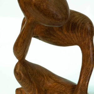 wood carving, stylistic rendering of small thinker, closeup