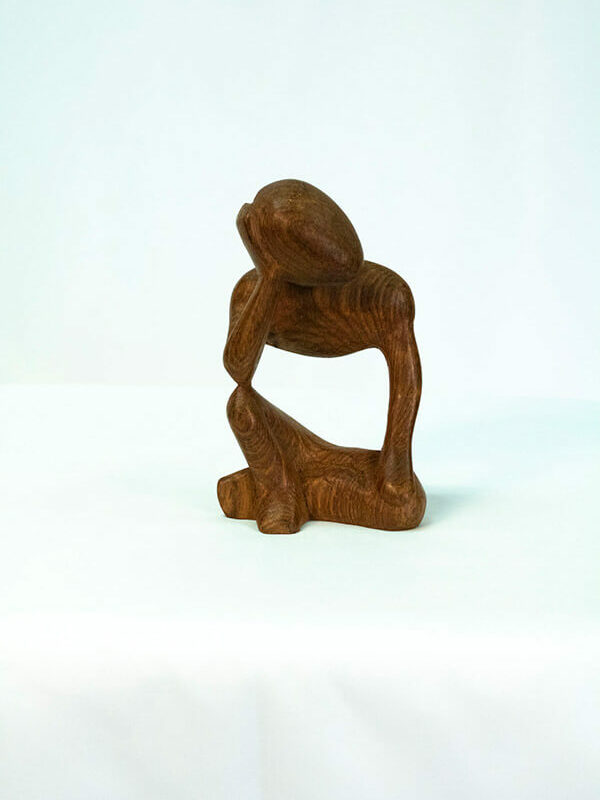 wood carving, stylistic rendering of small thinker, front