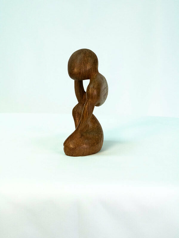 wood carving, stylistic rendering of small thinker, left