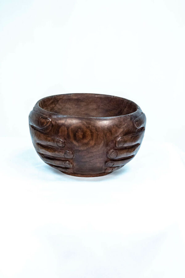 wooden bowl with hands carved on the sides, front