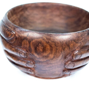 wooden bowl with hands carved on the sides, closeup