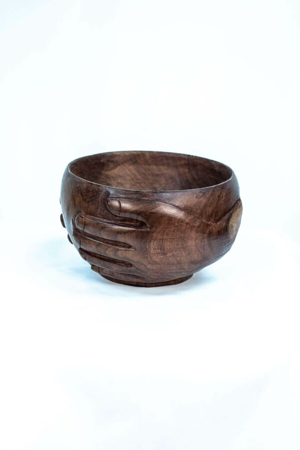 wooden bowl with hands carved on the sides, left