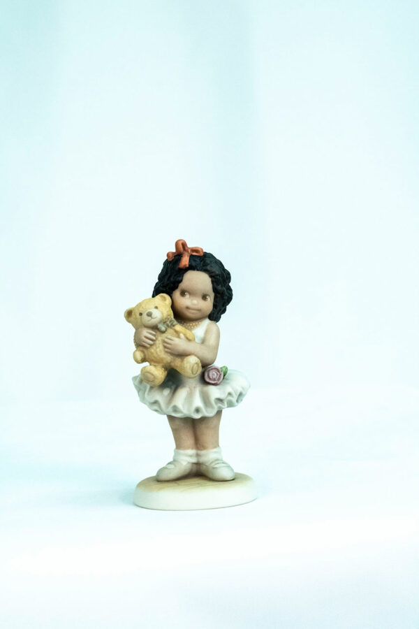 figurine, little girl holding teddy bear, front