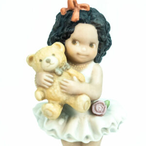 figurine, little girl holding teddy bear, closeup